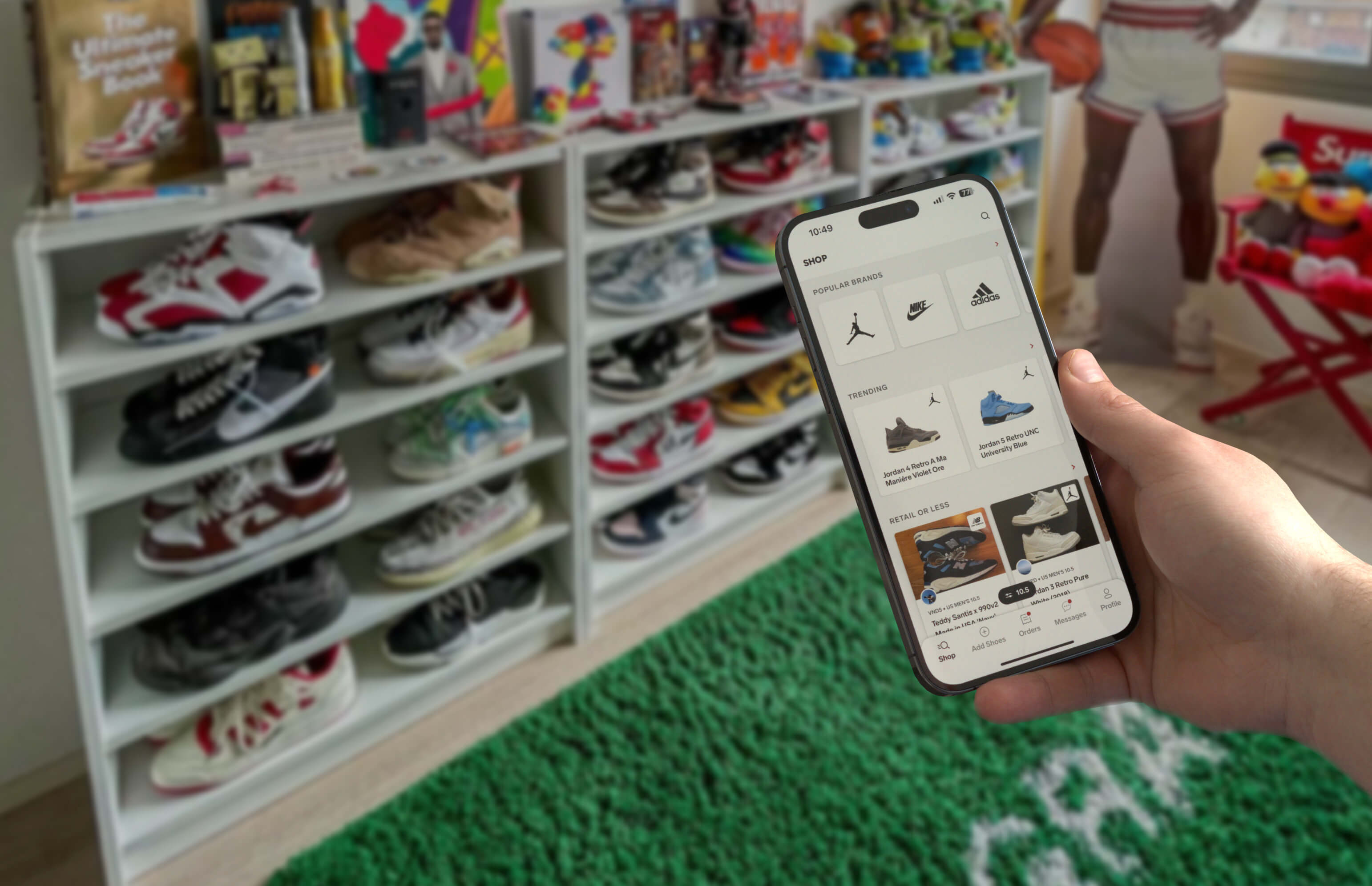 Image of a sneakerhead using the Collect mobile app infront of their sneaker collection
