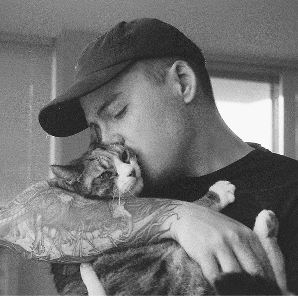 A portrait photo of Jordan and his cat Ava